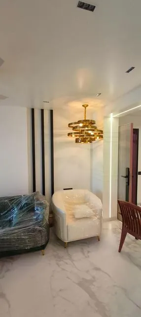 Foyer with chandelier and wall panelling