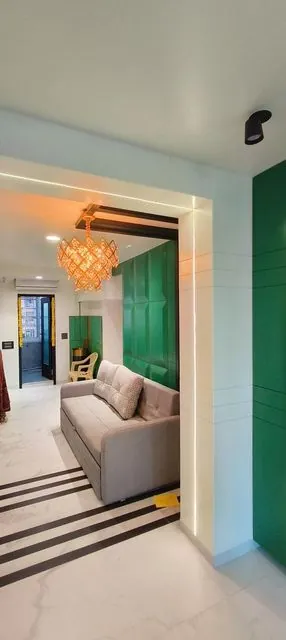 Living room with green accent wall and sofa