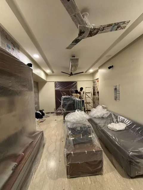 Living room painting with furniture covered