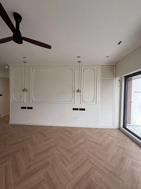 Bedroom with wall moulding and pendant lights