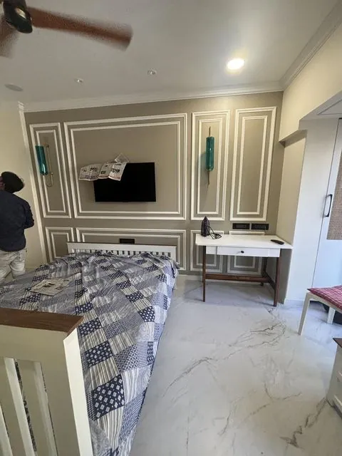 Bedroom with decorative wall moulding